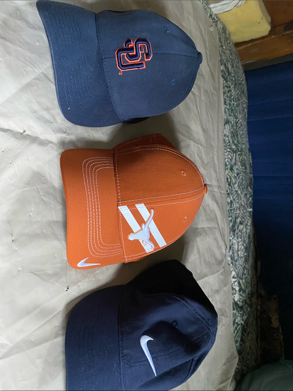 Three Nike hats